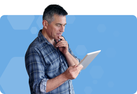 Man looking at a tablet and pondering with light blue background